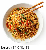 Wok with noodles, chopsticks and spring onion in white bowl on white background. Стоковое AI-изображение, AI-художник Иван Рябоконь / Фотобанк Лори