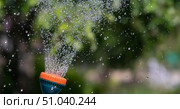 View of the spray of water from the sprayer in the garden. Стоковое фото, фотограф Siarhei Starastau / Фотобанк Лори