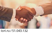 A detailed view of two individuals engaging in a handshake, demonstrating mutual agreement or greeting in a professional or friendly setting. Стоковое AI-видео, аниматор Данила Большаков / Фотобанк Лори