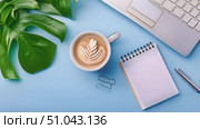 A cup of coffee and a notebook are placed on a blue surface. The steam rises from the mug, and the notebook is open with a pen next to it. Стоковое AI-видео, аниматор Данила Большаков / Фотобанк Лори