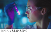 Scientist conducts experiment with glowing liquid in modern laboratory during nighttime. Стоковое AI-видео, аниматор Сергей Толмачёв / Фотобанк Лори