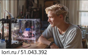 Young inventor showcases 3D printing project in bright workshop during afternoon hours. Стоковое AI-видео, аниматор Сергей Толмачёв / Фотобанк Лори