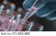 Experiment with colorful liquids in laboratory setting demonstrates precise pipetting technique and chemical reactions. Стоковое AI-видео, аниматор Сергей Толмачёв / Фотобанк Лори