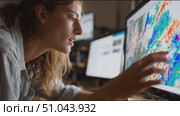 Young woman analyzes weather patterns and data using advanced technology at modern workspace. Стоковое AI-видео, аниматор Сергей Толмачёв / Фотобанк Лори