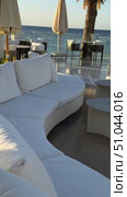 Luxury Arabian resort Empty tables and chairs along white buildings Round tables and chairs at an open-air restaurant An empty cafe, restaurant terrace in an urban environment modest lush vegetation greenery. Seating, vintage tables and chairs served for guests. Luxurious reception table Tableware on tablecloths.Interior of restaurant with orange chairs, tables, brick walls. Empty eatery features bar counter, loft design, modern lighting, large windows. Cafe is ready to serve food, beverages for clients. Стоковое видео, видеограф Zita Khasanova / Фотобанк Лори