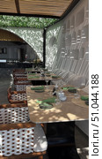 Restaurant furniture tables, chairs on patio provide outdoor dining at cafe on a bright day.Outdoor seating with stone arches and greenery. Cozy, peaceful. Tables and chairs offer a pleasant, sunny relaxation spot Table and chairs in backyard. Стоковое видео, видеограф Zita Khasanova / Фотобанк Лори