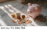 Piggy bank with coins on marble surface captures the essence of saving money for future goals. Стоковое AI-видео, аниматор Сергей Толмачёв / Фотобанк Лори