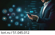 A man in a formal suit holding a modern smartphone. He is interacting with the device, possibly checking emails or browsing the internet. Стоковое AI-видео, аниматор Данила Большаков / Фотобанк Лори