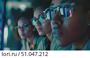 A team of programmers collaborates intensively on a software development project under the glow of computer screens. Стоковое AI-видео, аниматор Данила Большаков / Фотобанк Лори