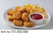 Chicken nuggets and french fries with ketchup on white background. Стоковое AI-видео, аниматор Юрий Поздников / Фотобанк Лори