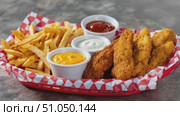 Crispy chicken tenders and french fries with dipping sauces. Стоковое AI-видео, аниматор Юрий Поздников / Фотобанк Лори