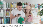 European spouses customer scans qr code on liquid detegrent label. Customer follows link and reads information about product, data on recycling of packaging. Стоковое видео, видеограф Яков Филимонов / Фотобанк Лори