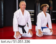 Men in kimono sitting on knees on tatami in gym. Стоковое фото, фотограф Яков Филимонов / Фотобанк Лори