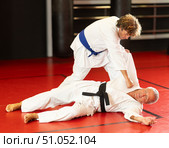 Karate with male athletes practicing, training and sparring in fight class. Стоковое фото, фотограф Яков Филимонов / Фотобанк Лори
