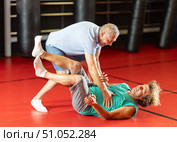 Male pupil clash with training manager during self-defense lesson, repulse charge, intensity of practice. Стоковое фото, фотограф Яков Филимонов / Фотобанк Лори