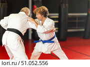 Karate with male athletes practicing, training and sparring in fight class. Стоковое фото, фотограф Яков Филимонов / Фотобанк Лори