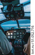 Inside the Cockpit: A Detailed View of Helicopter Controls and Instruments During a Scenic Flight Over the City at Dusk. Стоковое AI-видео, аниматор Владимир Федоров / Фотобанк Лори