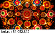 Happy Diwali celebration with lit diya oil lamps and colorful rangoli decoration on dark background. Hindu festival of lights concept with traditional clay lamp. Стоковое AI-изображение, AI-художник Павел Муравьев / Фотобанк Лори