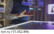 A Person Interacting with Advanced Holographic Technology Over a Smartphone, Showcasing Data Visualization and Information Analysis in a Modern Setting. Стоковое AI-видео, аниматор Владимир Федоров / Фотобанк Лори