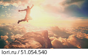 A man performs a daring leap off a cliff and into the open sky. Стоковое AI-видео, аниматор Данила Большаков / Фотобанк Лори