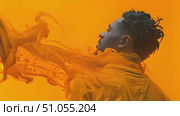 Silhouetted individual surrounded by swirling orange paint creates a dynamic visual effect. Стоковое AI-видео, аниматор Данила Большаков / Фотобанк Лори