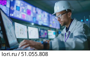Engineer spends work hours monitoring complex data systems in a high-tech control room environment. Стоковое AI-видео, аниматор Сергей Толмачёв / Фотобанк Лори