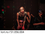 Nightclub Decadence as Woman Rides Shoulders Surrounded by Party Goers (2021 год). Редакционное фото, фотограф Aleksandr Golubev / Фотобанк Лори