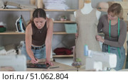 Dressmakers create clothes according to individual measurements. Fashion designer draws the design of the clothes on a tablet, and tailor checks the quality of the sample on the mannequin. Стоковое видео, видеограф Яков Филимонов / Фотобанк Лори