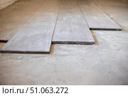 Close-up of large format ceramic tiles being laid on cement screed. Стоковое фото, фотограф Коханова Наталья / Фотобанк Лори