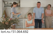 At kitchen parents scold standing daughter for bad behavior, mother clean dish in background. Стоковое видео, видеограф Яков Филимонов / Фотобанк Лори