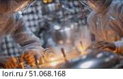 Researchers conduct experiments in a clean room while wearing protective suits and safety gear in a laboratory setting. Стоковое AI-видео, аниматор Сергей Толмачёв / Фотобанк Лори