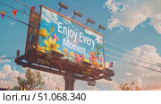 A billboard covered in blooming flowers with the message Enjoy Every Moment displayed prominently. Стоковое AI-видео, аниматор Данила Большаков / Фотобанк Лори