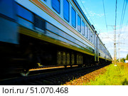 A train is moving down the tracks with the windows open. Russia. Moscow oblast. 14.08. 2025. Редакционное фото, фотограф Ярославский Максим / Фотобанк Лори