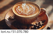 Enjoying a beautifully crafted latte with intricate milk art in a cozy cafe setting. Стоковое AI-видео, аниматор Ekaterina Ismagilova / Фотобанк Лори