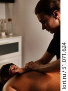 Expert Hands Performing a Therapeutic Massage in a Serene Indoor Setting for Relaxation and Healing. Стоковое фото, фотограф Aleksandr Golubev / Фотобанк Лори