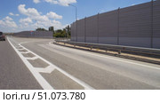 Soundproof fencing along the expressway. Hyperlapse. Shooting in motion. A barrier near an asphalt road. Highway. The highway. Стоковое видео, видеограф Константин Мерцалов / Фотобанк Лори