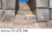 Ruins of an ancient Inca fortress. A stone staircase rises between the walls. A narrow passage. The masonry is made of sanded and hewn large boulders. Inca stone architecture. Peru. Cusco.Sacsayhuaman. Стоковое фото, фотограф Вера Ивановна Кубарева / Фотобанк Лори
