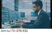 A professional analyzes data trends on multiple screens in a contemporary office environment. Стоковое AI-видео, аниматор Данила Большаков / Фотобанк Лори