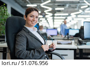 Successful business woman sitting at her desk in the office with glasses in her hands. Стоковое фото, фотограф Михаил Решетников / Фотобанк Лори