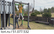 Kids engaging in outdoor fun at the park, running around and playing games on a bright summer day during school holidays. Стоковое видео, видеограф Ирина Старикова / Фотобанк Лори