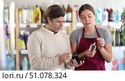 friendly female sales assistant presenting different fragrances, helping customer choose perfect scent. Стоковое видео, видеограф Яков Филимонов / Фотобанк Лори