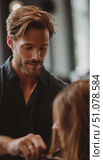 Hair stylist expertly cuts and styles hair in a modern salon setting during the afternoon. Стоковое AI-видео, аниматор Сергей Толмачёв / Фотобанк Лори