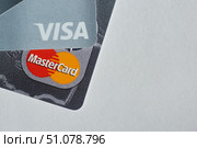 A set of Visa and Mastercard Bank credit cards lies on a white surface. The concept of the economy and the banking system, the financing (2020 год). Редакционное фото, фотограф Наталия Кирсанова / Фотобанк Лори