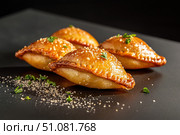 An elegant display of empanadas showcases each pastry on a neutral ceramic plate. The minimalist presentation highlights the variety and artisanal quality of the fillings and design. Стоковое AI-изображение, AI-художник Nart / Фотобанк Лори