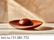 A perfectly crafted chocolate mousse with a glossy mirror glaze. This decadent, single-serving dessert captures the eye with its luminous shine and artful presentation. Стоковое AI-изображение, AI-художник Nart / Фотобанк Лори