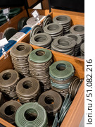 Stacks of round plastic trim rings for stretch ceiling installation, used to secure and finish openings for recessed lighting fixtures. Стоковое фото, фотограф Татьяна Терехина / Фотобанк Лори