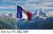 French flag waving against a backdrop of majestic mountains and a clear blue sky. The scene captures the essence of Bastille Day celebrations in France. Стоковое AI-видео, аниматор Nart / Фотобанк Лори