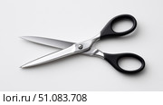 Sharp scissors for precise cutting on a simple gray backdrop. Стоковое AI-изображение, AI-художник Katsiaryna Repich / Фотобанк Лори