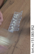 the person fills a plastic organizer with pills, distributing a weekly dose of medicines. medicine and healthcare concept. Стоковое видео, видеограф Дмитрий Цветков / Фотобанк Лори