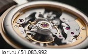 Close-up of a mechanical watch movement showcasing intricate gears and jewels. The design features a blend of silver and gold tones. Стоковое AI-видео, аниматор Nart / Фотобанк Лори